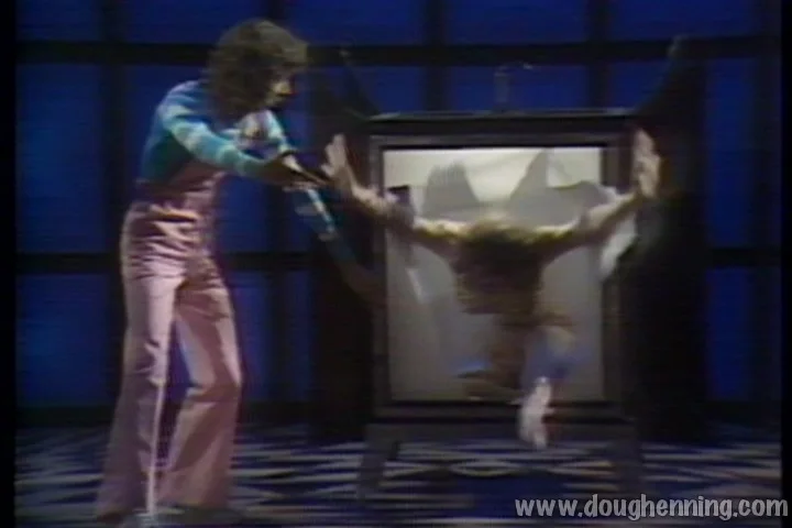 Doug Henning in pink flared trousers working the Shadow Box illusion during the live 1975 broadcast
